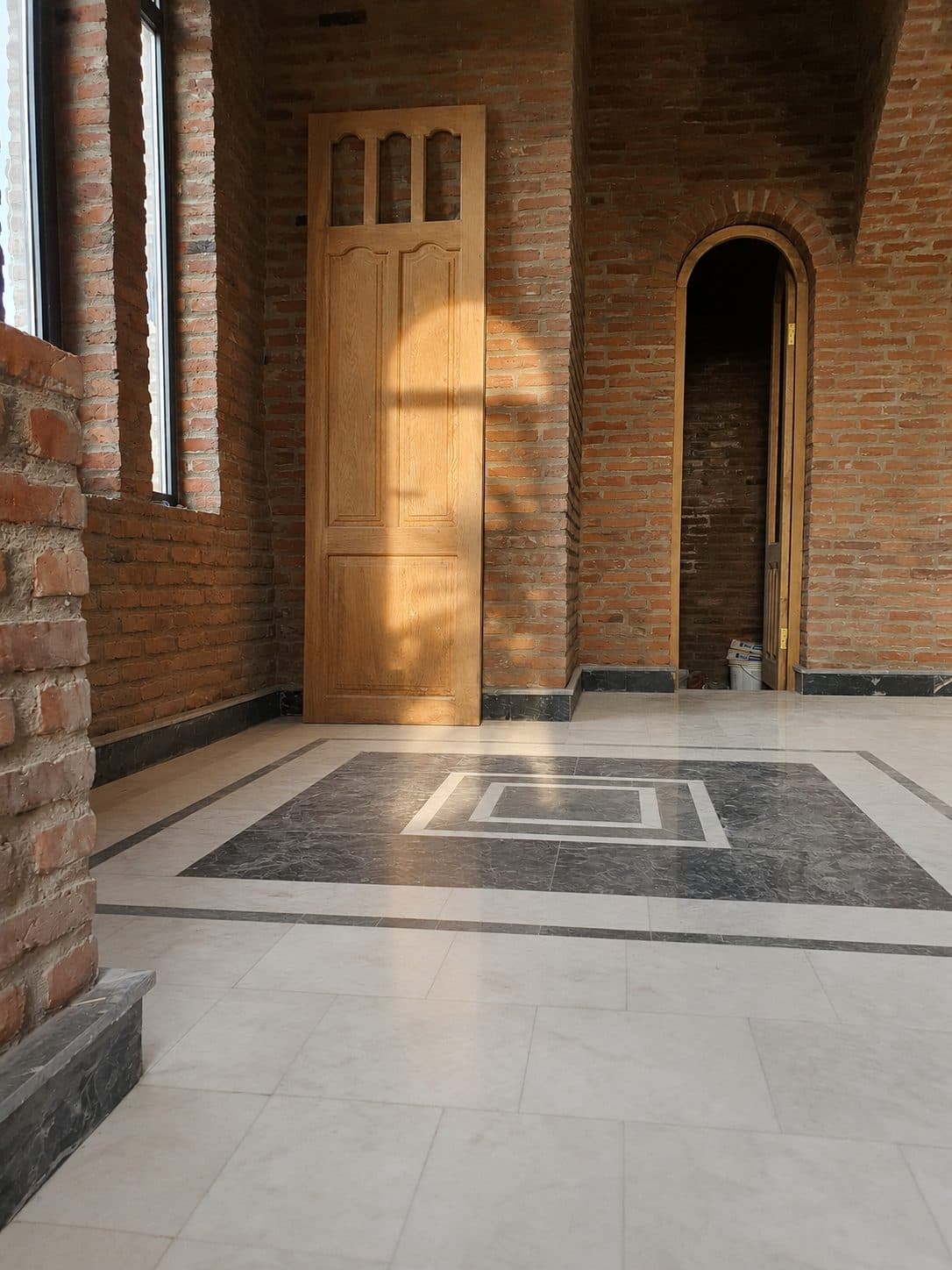 One of the wooden doors and the marble inlay floor